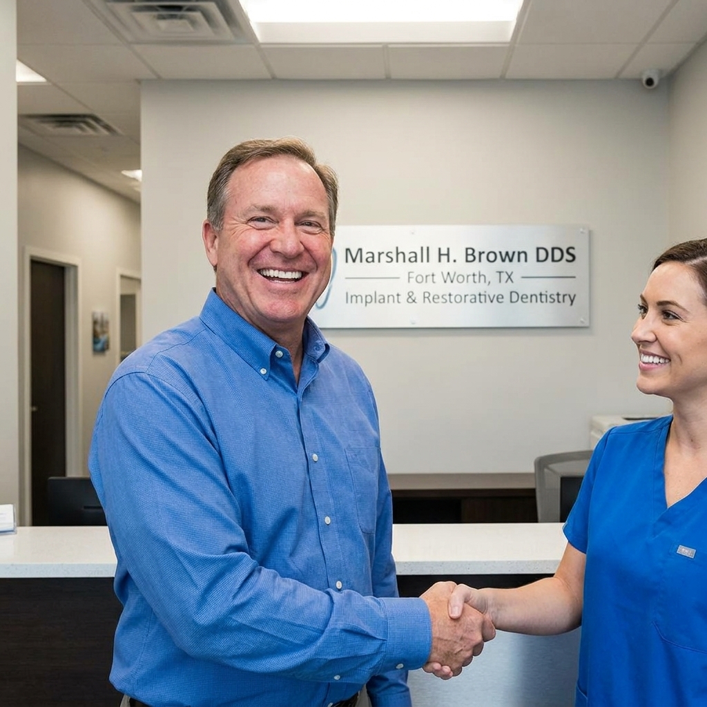Happy patient smiling confidently after successful dental implant restoration at Marshall H. Brown DDS Fort Worth Texas